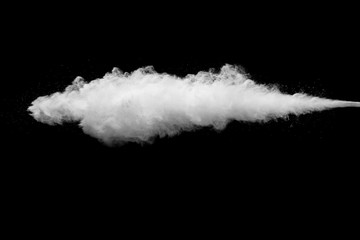 White powder explosion isolated on black background. White dust particles splash.
