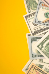 One hundred dollar banknotes on colored background top view, with empty place for your text business money concept.