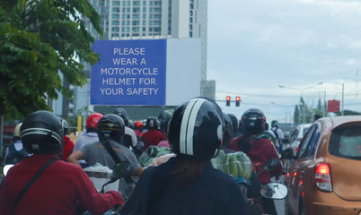 Group of motorbike rider stop at red light and everyone wear helmet for safety.