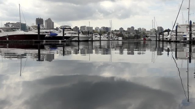 Vancouver City, British Columbia, Western Canada, False Creek, Pacific ocean coast inlet. Panoramic view on harbor water with sail boats and skyline eflection.