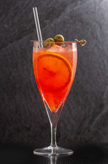 drinks lemonade with different flavors: watermelon, grapefruit, blueberries, orange. different wine glasses on black background
