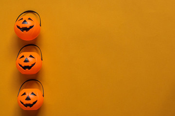 Halloween holiday concept, Spooky pumpkin bucket in orange background with copy space for text, Top flat view wallpaper