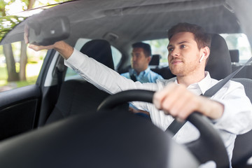 transport, vehicle and people concept - male driver with wireless earphones or hands free device...
