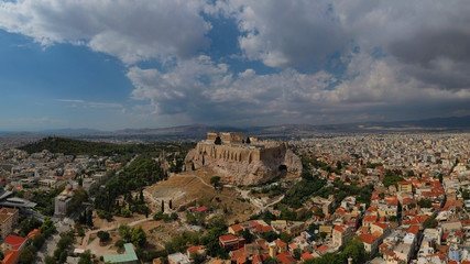 Obraz premium Aerial photo of unique Masterpiece of Ancient times the Parthenon on top of iconic Acropolis hill with beautiful clouds and blue sky, Athens, Attica, Greece