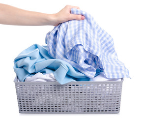 Basket with laundry clothing in hand on white background isolation