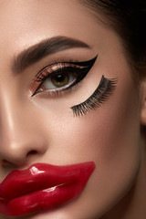 Naklejka premium Closeup Portrait of Beauty Woman with Perfect Makeup. Clean perfect skin, sexy lips and dark eyebrows. Fashion glamour female face