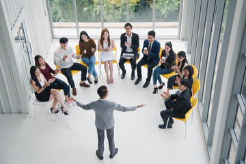 Seminar group, Successful young Asian business man and woman, the man speaker presenting to...