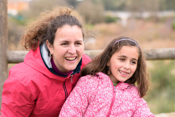 Fototapeta premium Mother and daughter, happy in the countryside on a winter day