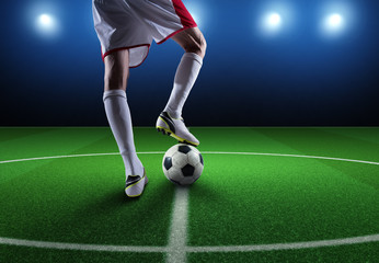 Close up of a soccer striker ready to kicks the ball at the stadium