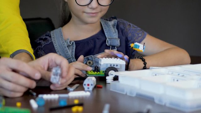 Kids creating robots with teacher. Early development, innovation, modern technology concept