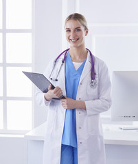 Portrait of a happy smiling young doctor in headset in office