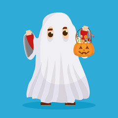 little boy with ghost disguise and candies pumpkin