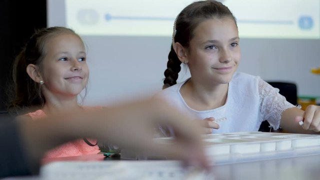 Children in the classroom make figure from the designer