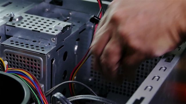 Serviceman is checkin computer cables