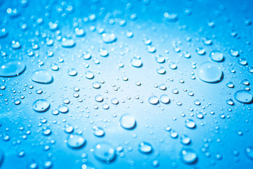Water droplets on light blue background