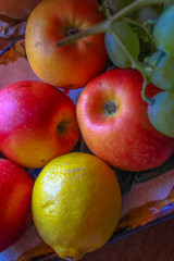 Naklejka na ściany i meble Autumn fruits: apples and grapes.