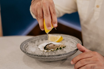Oysters served in a restaurant seasoned with lemon juice