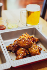 Golden Crunchy Korean Fried Chicken (basic Huraideu-Chikin) mix with spicy sauce, chili and garlic. Served with cold beer in frozen glass.
