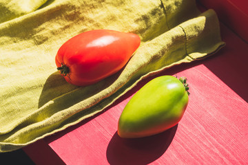 red and green tomatoes. ripe and not ripe tomatoes on the windowsill. ripening vegetables concept.