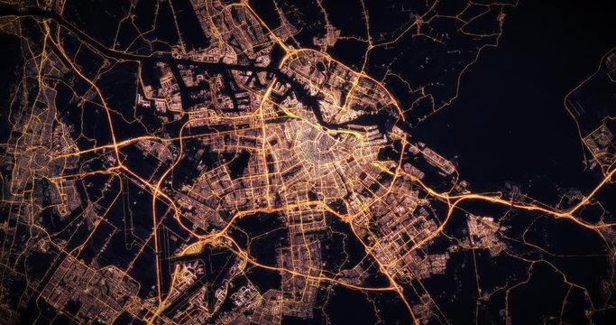 Aerial night view of city of Amsterdam Netherlans. Traffic and street light glowing. Camera flying high above, moving slowly forward from space filming cinematic straight down. 3d animation rendering.