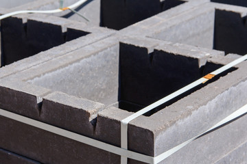 Concrete blocks for ventilation shafts in a new house. A pallets of ventilation blocks on a construction site. Materials for the construction of a new building.