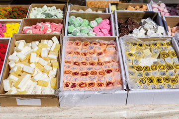 Mixed types of traditional Turkish delight or lokum displayed for sale at an weekend street food market