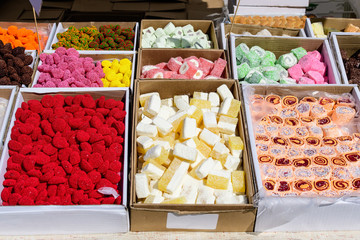 Mixed types of traditional Turkish delight or lokum and jelly candies displayed for sale at an weekend street food market