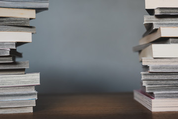 tall stacks of books on wood table