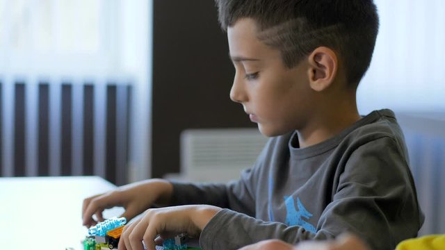Children in the classroom make figure from the designer