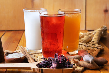 Set of mexican fresh water also called "aguas frescas". Hibiscus, tamarind and horchata on wooden background