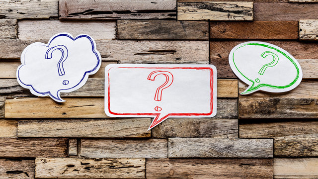 Speech bubbles on wooden background : ?