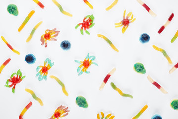pattern with colorful gummy spiders and worms isolated on white, Halloween treat