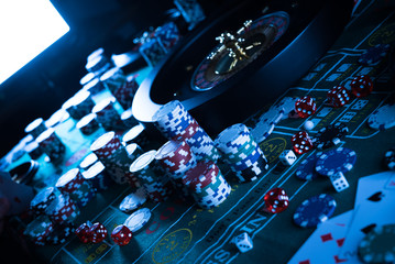 Casino theme. High contrast image of casino roulette, and poker chips