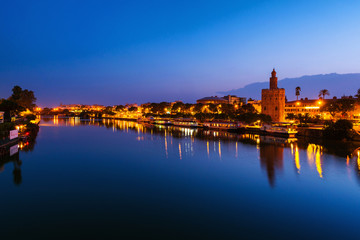 View of La Torre de Oro Tower of Gold in Seville, Spain at night