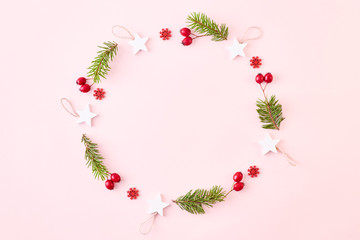 Flat lay christmas frame with spruce branches and christmas decorations on a color background