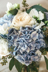Close-up of a bouquet of flowers - blue Garden Hydrangeas and white Peony Roses.