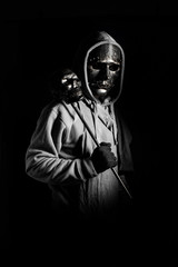 man in halloween costume of ghost evil with black metal mask and wear hooded in darkness concept