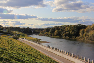 Fototapeta na wymiar Smolensk, Russia, Dnepr river, and City embankment in autumn sunny day on blue sky background, view on left from observation deck