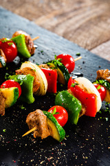 Grilled shashliks with chicken on blask stone plate © Jacek Chabraszewski