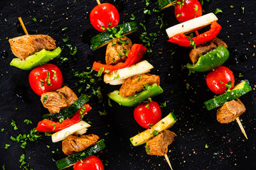 Grilled shashliks with chicken on blask stone plate © Jacek Chabraszewski