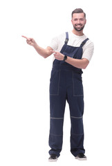 smiling man in overalls pointing to a copy of the space