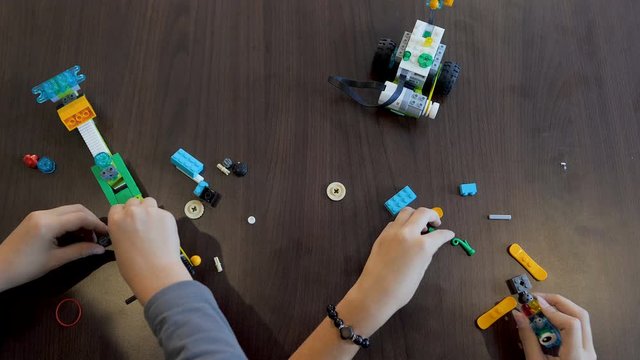 Children in the classroom make figure from the designer