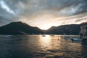 Beautiful view of the Kotor Bay in Montenegro at sunset. Natural mountain landscape and sea with boats or yachts. Near the small town of Perast.