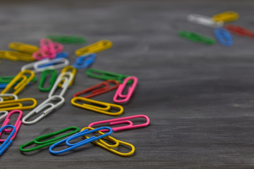 Multicolored paper clips on a dark background