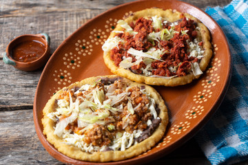 Mexican food: sopes of Chorizo and beef picadillo with cheese and beans