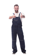 in full growth. friendly man in overalls showing thumbs up