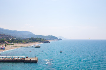 Kanakly, Alanya, Turkey - April 24, 2019: Sunny Alanya beach in Turkey with sea view. View from the fortress on the mountain. Mediterranean Sea