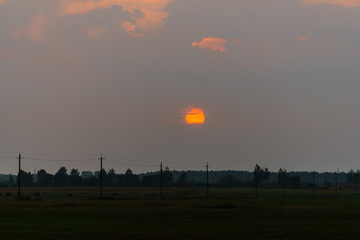 Beautiful sunset over the field. Evening landscape.
