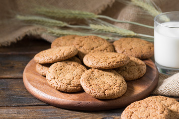 Oatmeal cookies on a wooden round Board. Rustic style