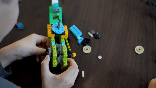 Children in the classroom make figure from the designer